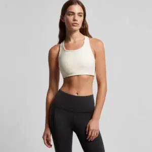 Person in a cream sports top and black leggings, ready for adventure
