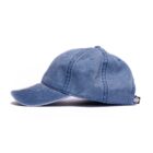 Blue denim baseball cap, side view, with a small black tag on the back.