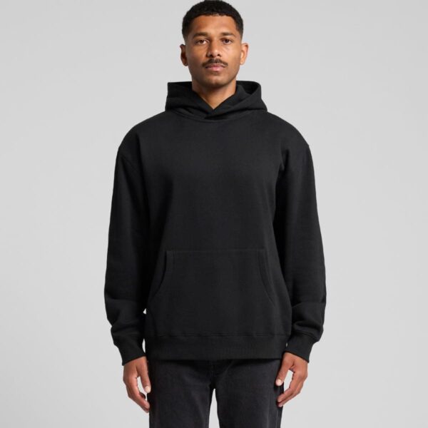 Man standing and wearing a plain black Ascolour Hoodie sweatshirt with hands at his sides.