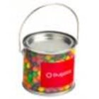 Small metal bucket filled with colorful candy, featuring a red label on the front.