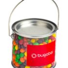 Small clear paint can filled with colorful candy, labeled bugaboo with a red sticker.