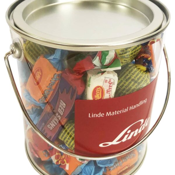 A clear paint can filled with assorted wrapped candies and a red Linde label on the front.