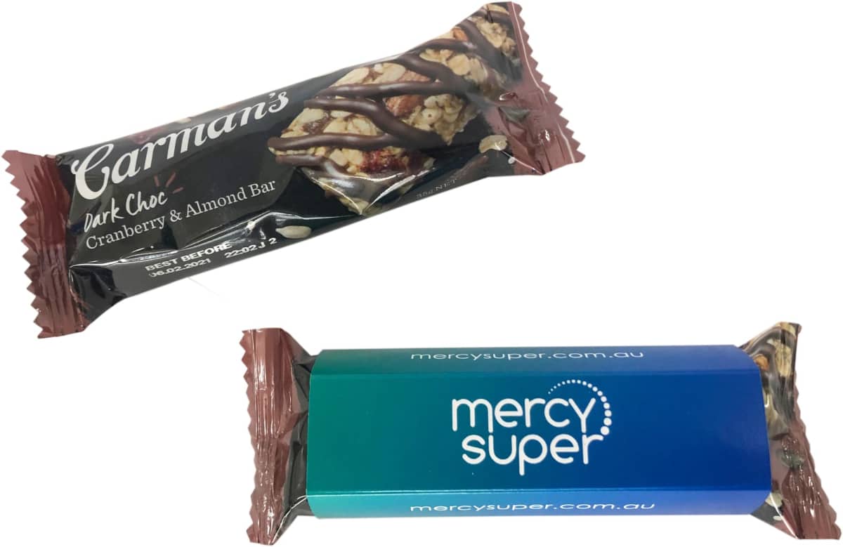 A Carmans snack bar and a blue Mercy Super-branded bar, both unopened.
