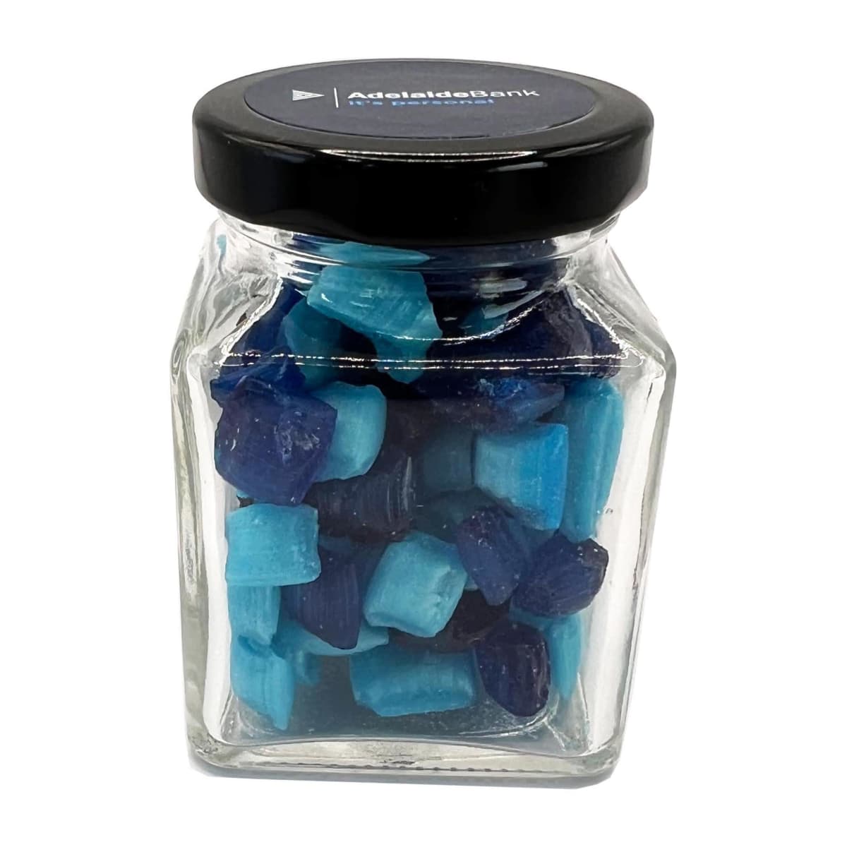 A glass jar filled with blue and dark blue candies, topped with a black lid.
