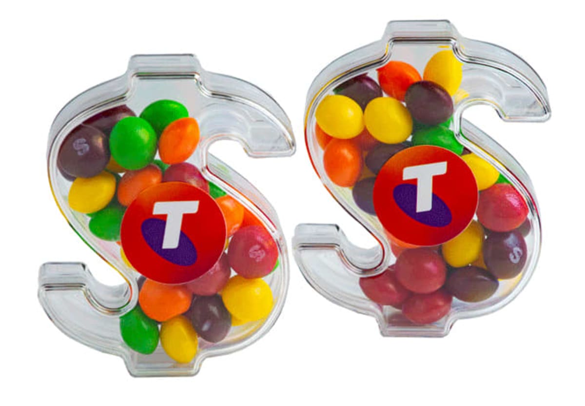 Two clear, dollar sign-shaped containers filled with colorful candies.
