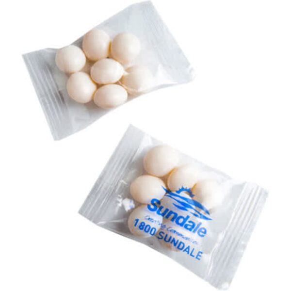 Two small clear packets, each containing five white, oval-shaped candies or mints.