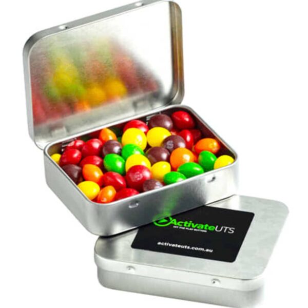 Open metal tin with colorful candies inside and another tin with a black ActivateUTS label.