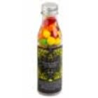 A clear bottle filled with colorful candy and sealed with a silver cap.