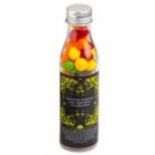 Clear bottle with silver cap, filled with colorful round candies, and black label with yellow design.