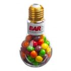 A light bulb-shaped container filled with colorful round candies.