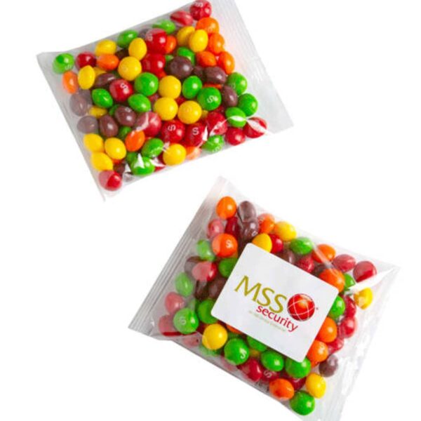 Two clear bags filled with colorful Skittles; one bag has an MSS Security logo sticker.