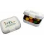 Two small white plastic containers, one open with colorful candies inside, one closed.