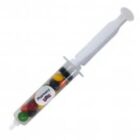 A plastic syringe filled with colorful candy, labeled Pharmacy.