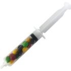 A plastic syringe filled with colorful candy-coated chocolates.
