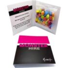 Greeting card with MONSTER HIRE text and a packet of colorful candy inside.