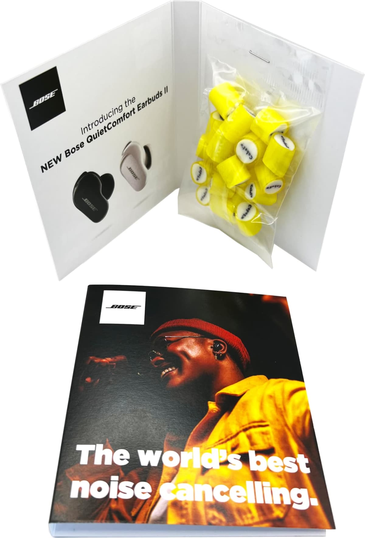 Open booklet with Bose earbuds image, yellow earplugs, and The worlds best noise cancelling.