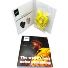 Open booklet with Bose earbuds, yellow earplugs, and a brochure reading The worlds best noise cancelling.