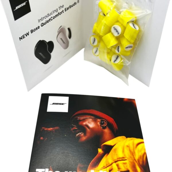 Open booklet with Bose earbuds image, yellow foam ear tips, and noise cancelling promo text.
