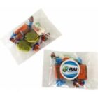 Two clear plastic bags containing assorted candies and a circular promotional item.