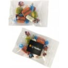 Two clear bags filled with assorted colorful candies, one bag with an LJ Hooker label.