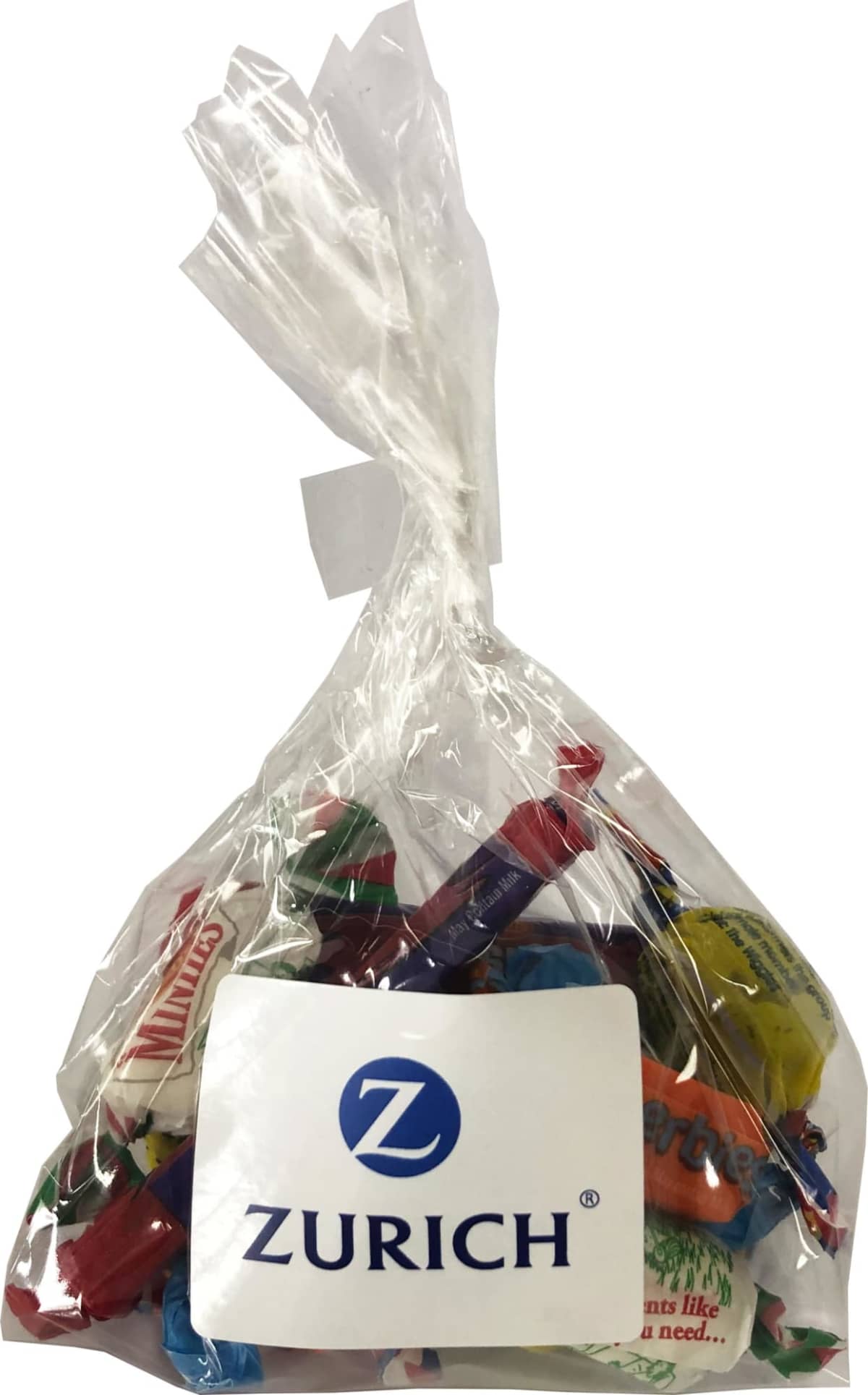 A clear plastic bag of assorted candies with a ZURICH logo label on the front.