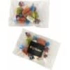 Two clear bags filled with assorted wrapped candies, one with a black label.