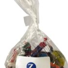 Clear bag of assorted candies with a white Zurich logo label on the front.