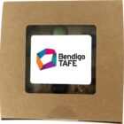 Brown box with a window showing a Bendigo TAFE logo and part of a cookie inside.