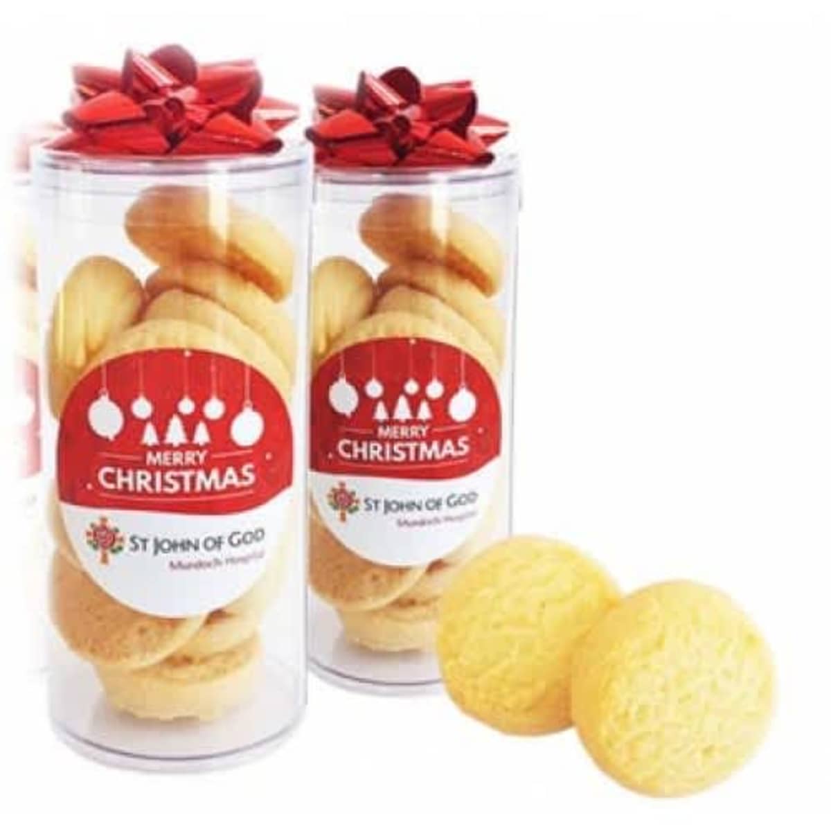 Two clear jars of cookies with red bows and Merry Christmas labels, plus two cookies in front.
