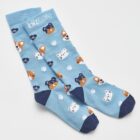 Blue socks with various cartoon dog faces and paw prints.