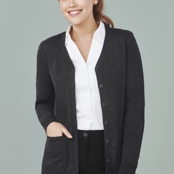 Person wearing a black cardigan over a white shirt against a plain background.