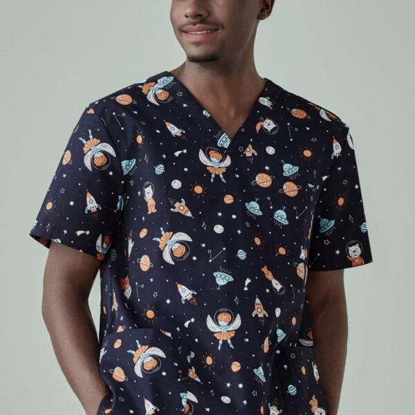 Person wearing space-themed scrubs smiles and stands against a light background.