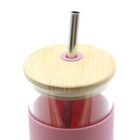 Red tumbler with bamboo lid and metal straw.