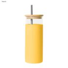 Yellow tumbler with a bamboo lid and metal straw, labeled Peach.