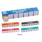 Rectangular weekly pill boxes in various colors, one compartment filled with yellow pills.