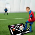 Child in red jersey playing a soccer training game on a field.