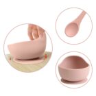 Pink silicone baby bowl with spoon and suction base, shown in close-up and separate views.