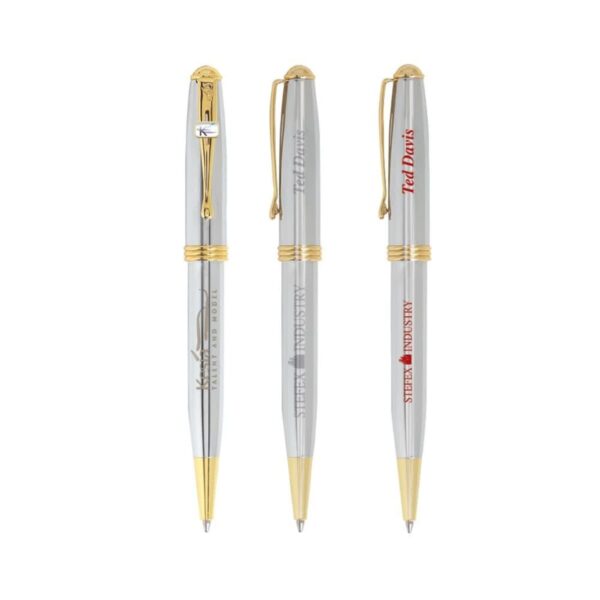 Three silver and gold ballpoint pens with different inscriptions on a white background.