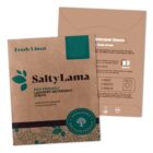 SaltyLama laundry detergent strips box and one detergent sheet with usage instructions.