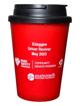 A red reusable cup featuring road safety, community program logos, and branded office supplies.