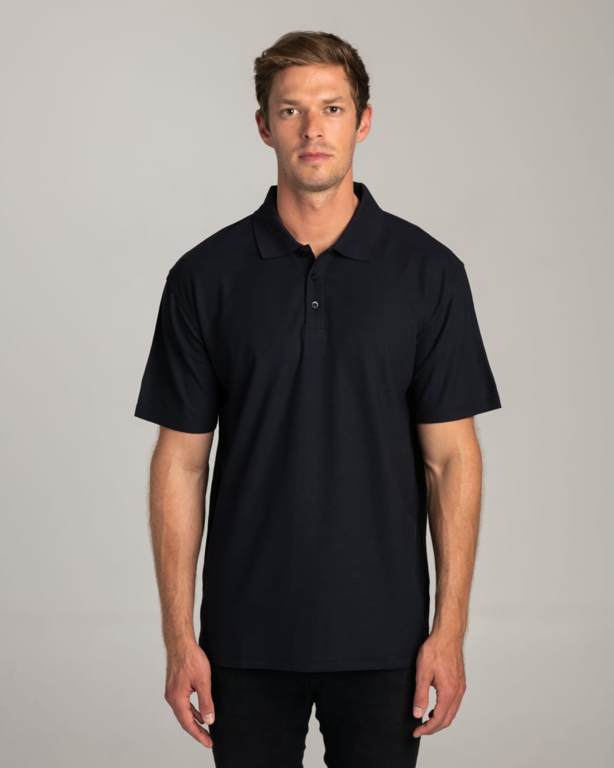 Man wearing a plain black polo shirt stands facing forward against a neutral background.