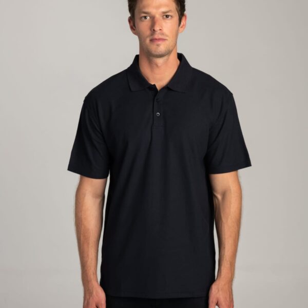 Man wearing a plain black polo shirt standing against a neutral background.