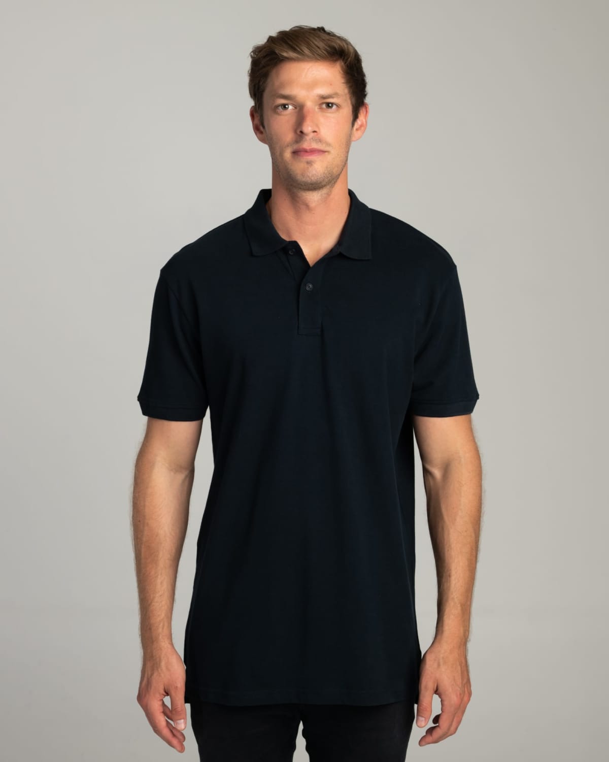 Man wearing a black polo shirt stands facing forward against a plain light background.
