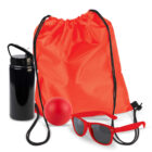 Red drawstring bag with sunglasses, stress ball, and a black bottle.