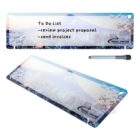 Transparent notepad with mountain, cityscape, and plane design showing a to-do list.