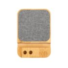 Wooden phone stand with a gray fabric speaker panel.