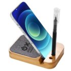 Phone and pen in a bamboo stand with a fabric pad.