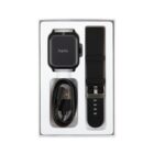 Smartwatch kit with black watch, extra strap, and charging cable in a box.