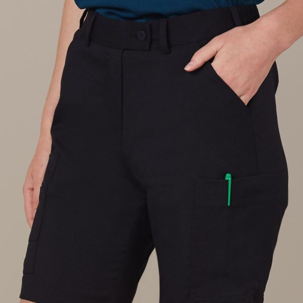 Person wearing black cargo shorts with hands in pockets.