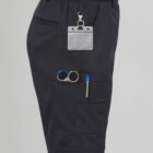 Person in black pants with tools in pockets and a blank name tag.